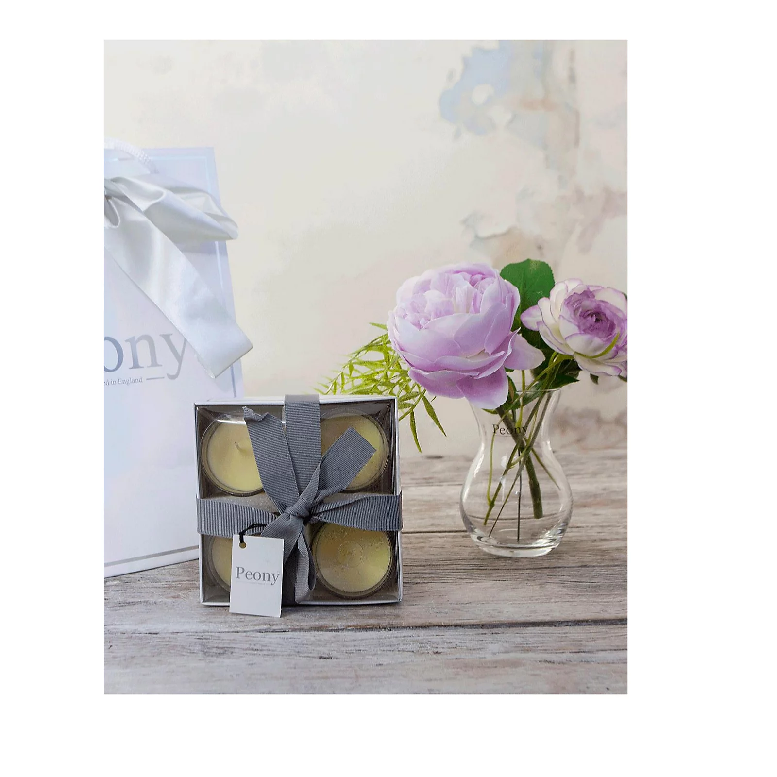 Peony Roses, Ranucula & Foliage in a Dainty Hourglass Vase w/ 4 Candles & Bag 3 Peony Roses, Ranucula & Foliage in a Dainty Hourglass Vase w/ 4 Candles & Bag