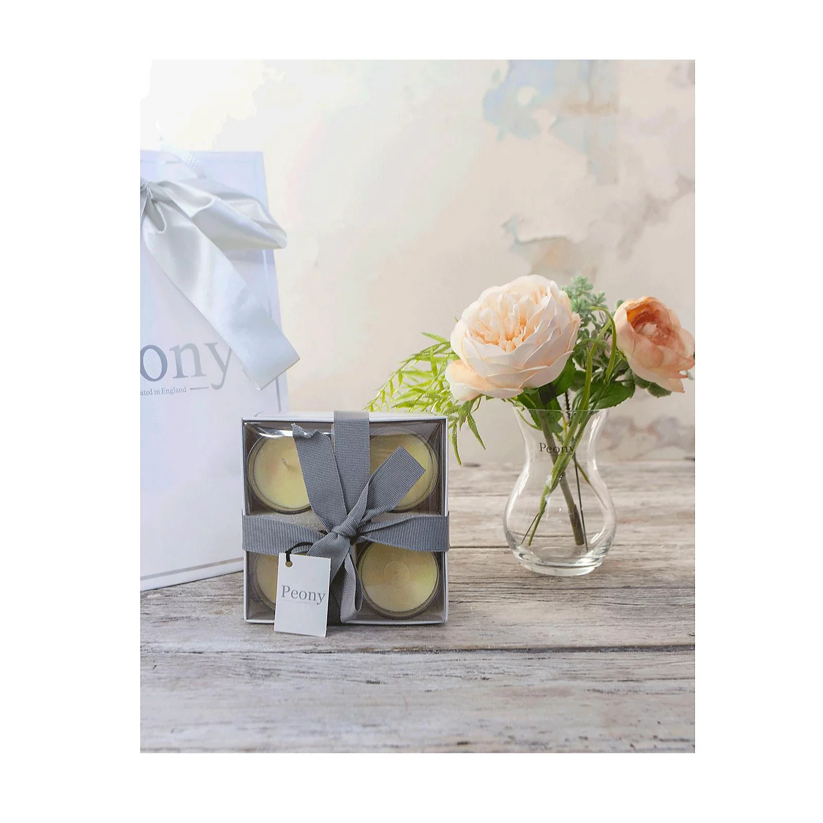 Peony Roses, Ranucula & Foliage in a Dainty Hourglass Vase w/ 4 Candles & Bag 4 Peony Roses, Ranucula & Foliage in a Dainty Hourglass Vase w/ 4 Candles & Bag